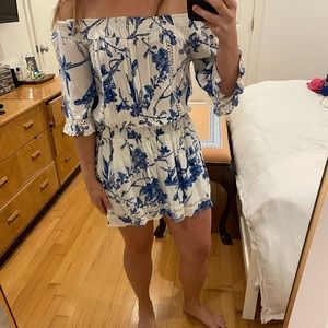 Blue and white romper with smocked waist and shoulder